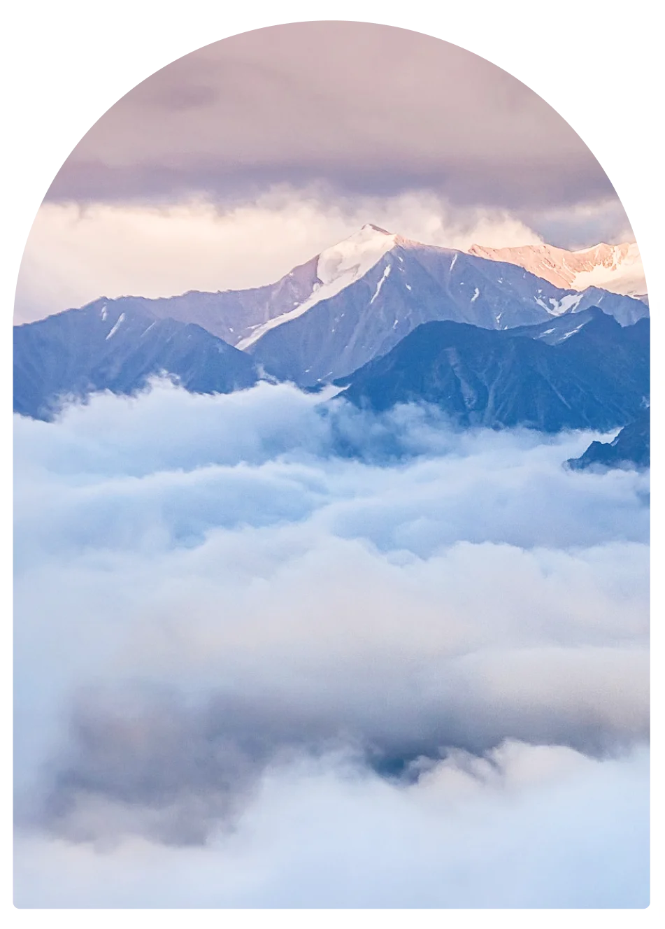 snowy mountain top in cloud cover